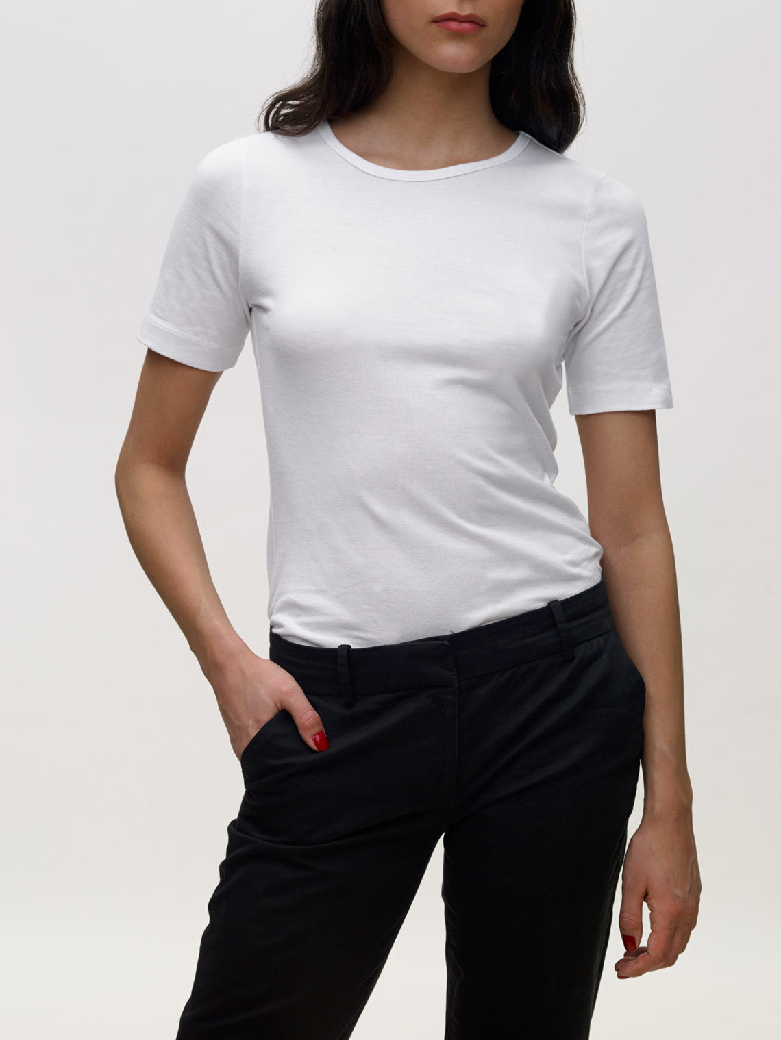 Model wearing white, crew neck, slim, KOTN t-shirt.