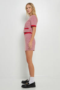 Model is wearing Scarlett Houndstooth Tweed Skirt in red and white