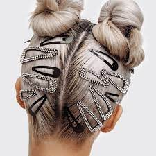UNIKONCEPT Lifestyle Boutique and Lounge; Kitsch Rhinestone Snap Clips pictured in a woman's hair. Rhinestone studded snap hair clips