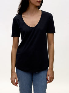 Model wearing black, v-neck, KOTN  t-shirt. 