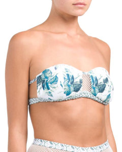 UNIKONCEPT Lifestyle boutique: Model is wearing a white strapless somedays loving bikini top. The emerald oasis bandeau top comes in a tropical greenery print, with a key hole of mesh fabric at the bust.