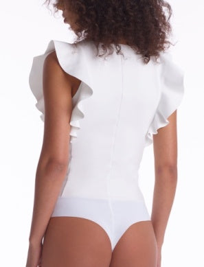 Model wearing Neoprene Ruffle Bodysuit in White from Commando with Ruffle detailing at the shoulders available at UniKoncept in Waterloo photo of back view