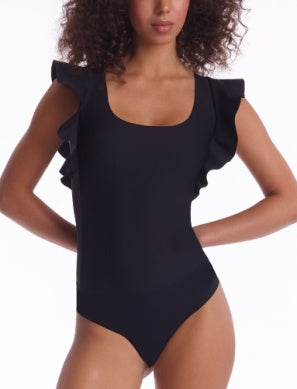 Model wearing Neoprene Ruffle Bodysuit in Black from Commando with Ruffle detailing at the shoulders available at UniKoncept in Waterloo